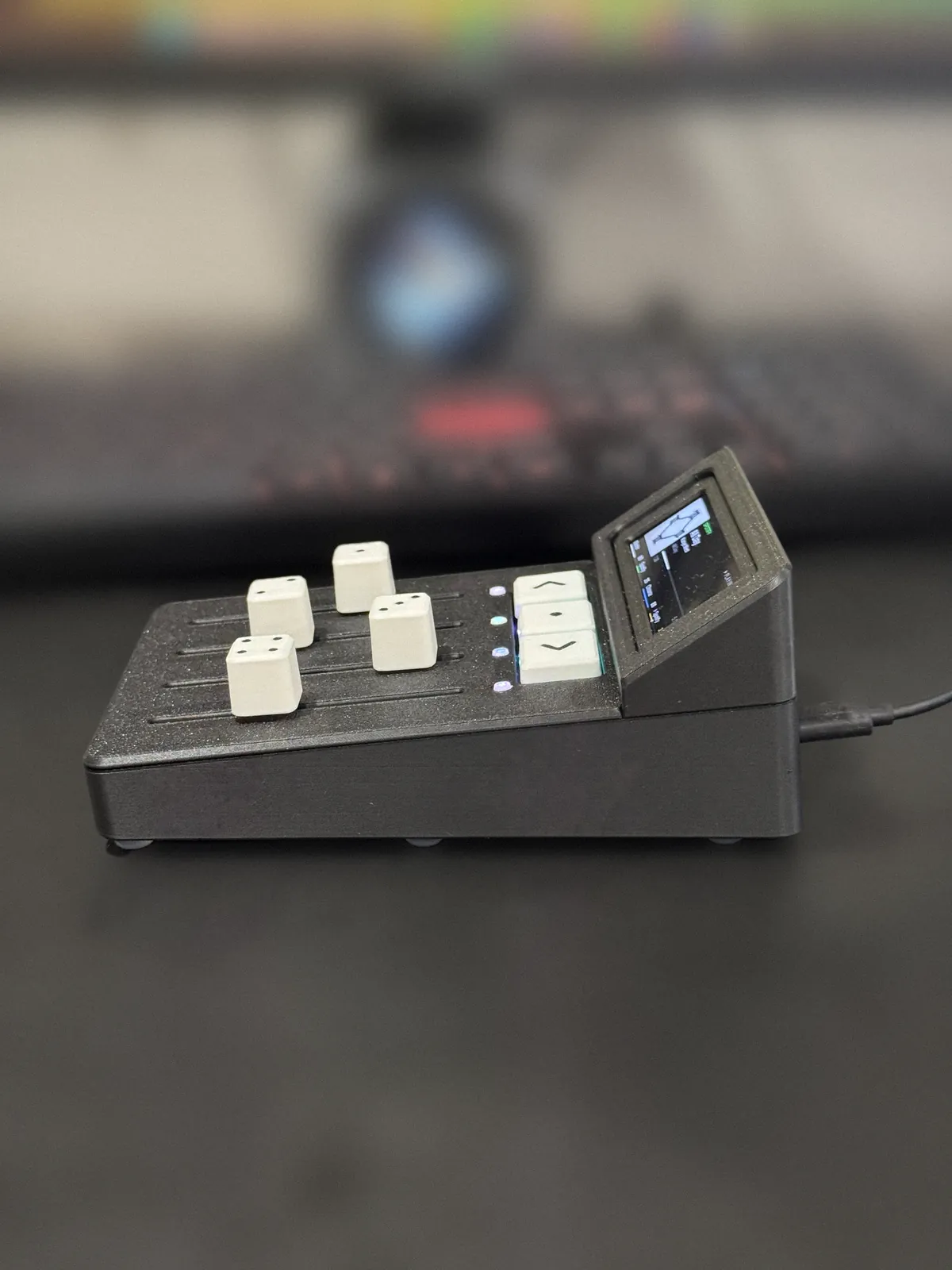 Trackside from the side, showing the sloped display housing and the USB-C cable.